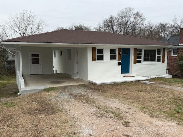 ranch-style house featuring a carport