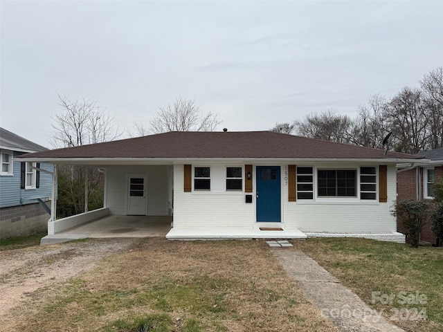 single story home with a carport and a front lawn