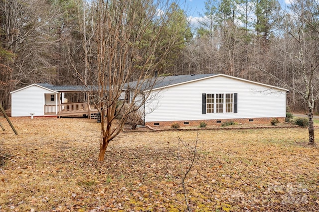 view of property exterior featuring a lawn and a deck