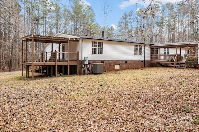 back of house featuring a wooden deck and central AC