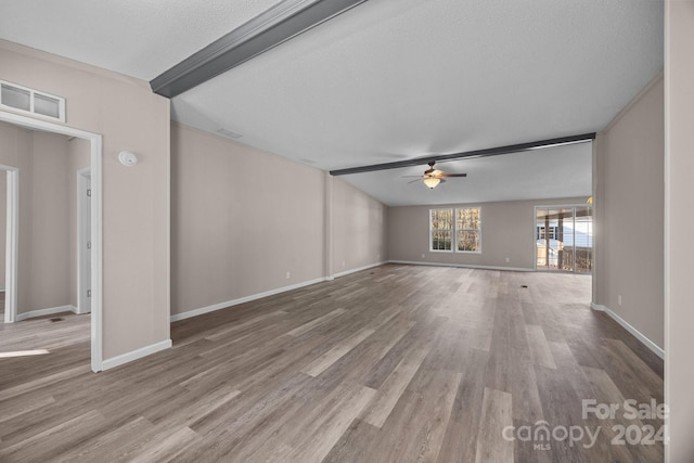 unfurnished living room featuring beam ceiling, a textured ceiling, light hardwood / wood-style flooring, and ceiling fan