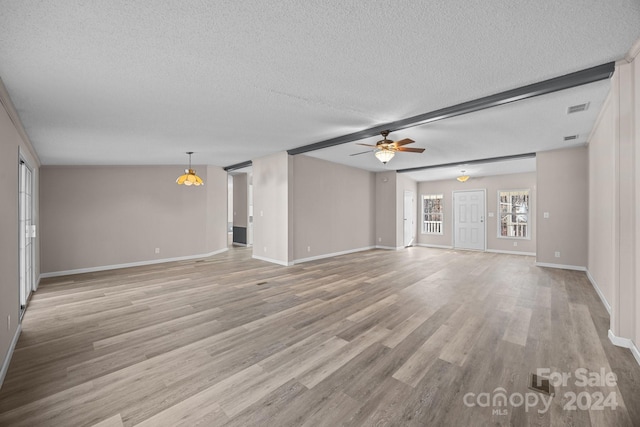 unfurnished living room with a textured ceiling, light hardwood / wood-style floors, and ceiling fan