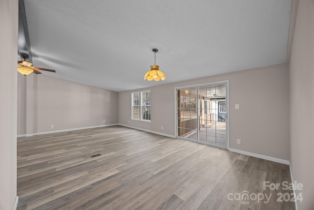 interior space with wood-type flooring, a textured ceiling, and ceiling fan