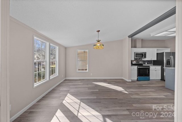 unfurnished dining area with light hardwood / wood-style floors and lofted ceiling