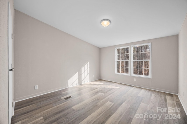 unfurnished room featuring hardwood / wood-style floors