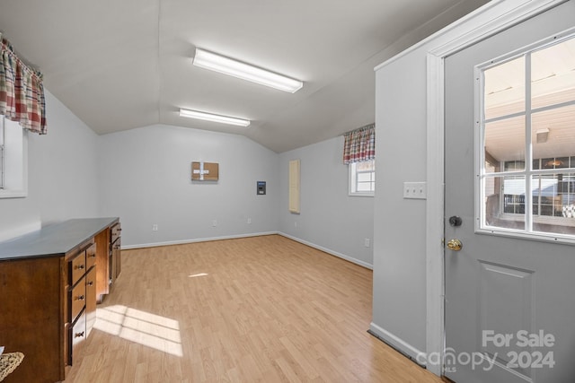 laundry area with plenty of natural light and light hardwood / wood-style flooring