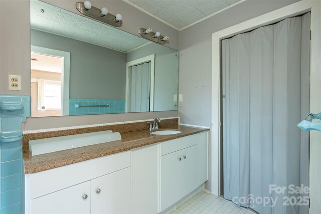 full bathroom with double vanity and a sink