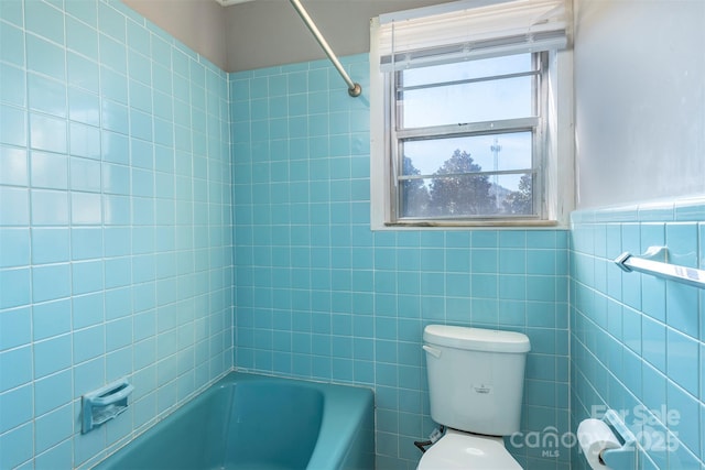 full bath featuring tile walls, a wainscoted wall, shower / bathtub combination, and toilet