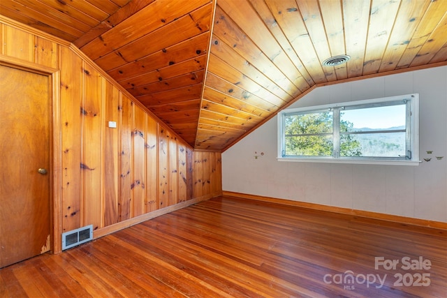 bonus room with visible vents, wood ceiling, and wood finished floors