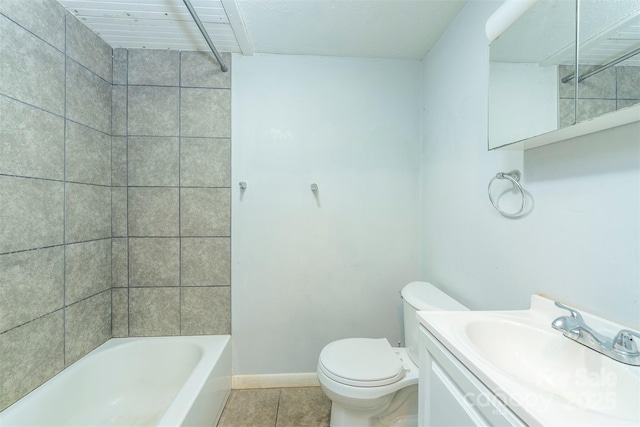 bathroom featuring baseboards, toilet, tile patterned floors, washtub / shower combination, and vanity