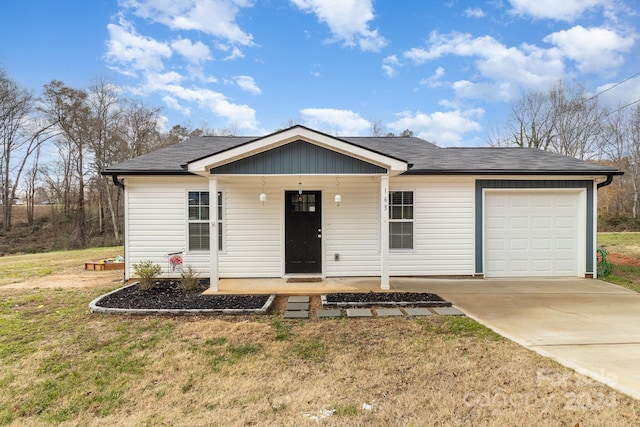 view of front of house with a front lawn, covered porch, and a garage