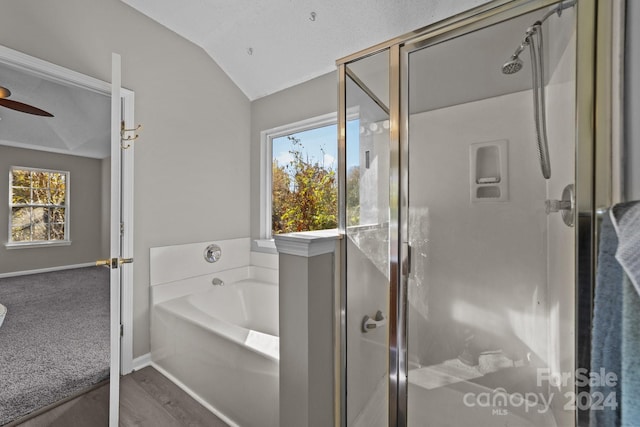 bathroom featuring a wealth of natural light, independent shower and bath, lofted ceiling, and wood-type flooring