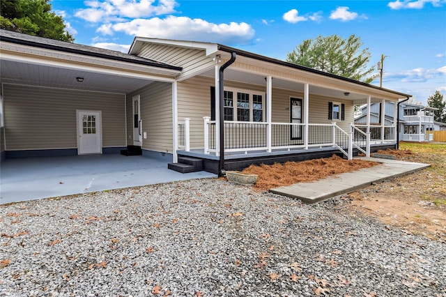 view of front of property with a carport and covered porch