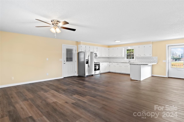 kitchen featuring dark hardwood / wood-style flooring, white cabinets, a healthy amount of sunlight, and appliances with stainless steel finishes