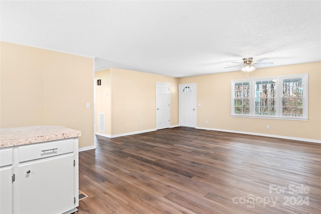 unfurnished living room with ceiling fan, hardwood / wood-style floors, and a textured ceiling