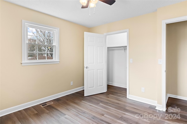 unfurnished bedroom with a closet, light hardwood / wood-style floors, and ceiling fan