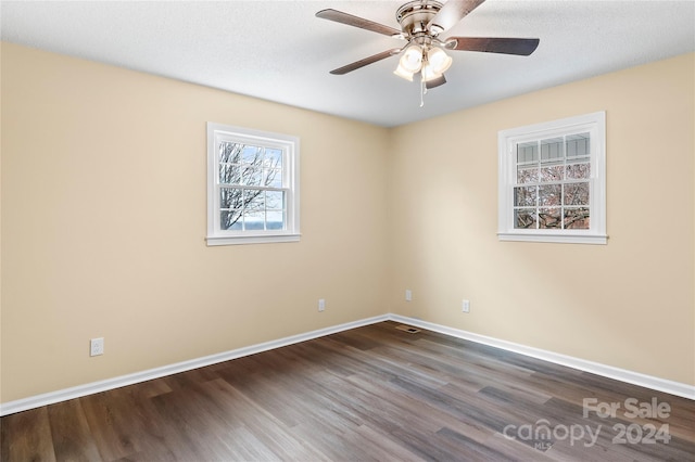 empty room featuring hardwood / wood-style flooring, ceiling fan, and a textured ceiling