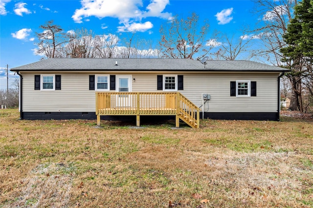 rear view of property with a lawn and a wooden deck