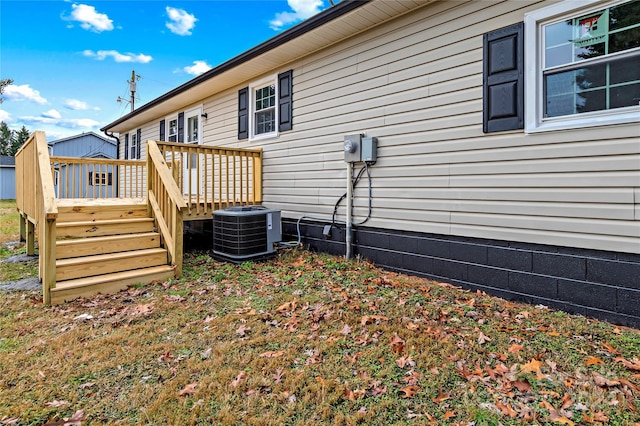 exterior space with a wooden deck and central AC