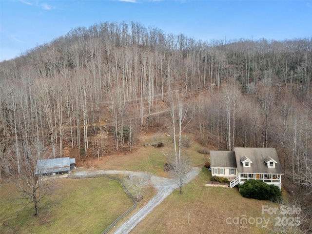 birds eye view of property with a forest view