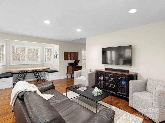 living area with recessed lighting, baseboards, and wood finished floors