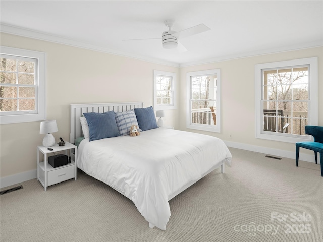 bedroom featuring ornamental molding, light colored carpet, visible vents, and baseboards