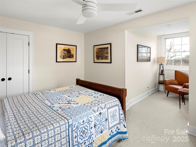 carpeted bedroom featuring a ceiling fan, a closet, visible vents, and baseboards