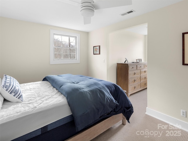 carpeted bedroom with ceiling fan, visible vents, and baseboards