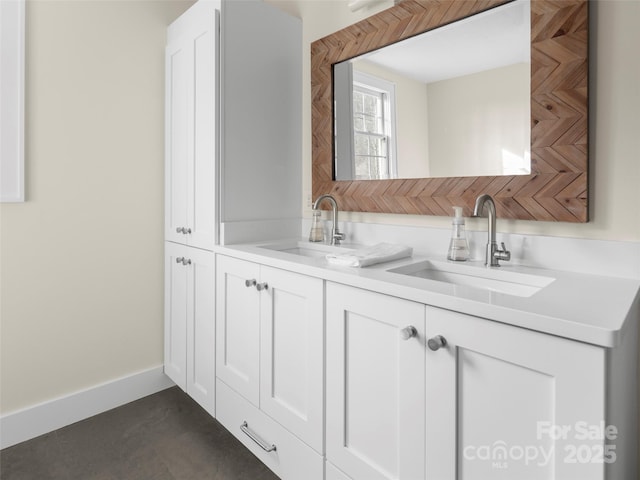 bathroom featuring a sink, baseboards, and double vanity