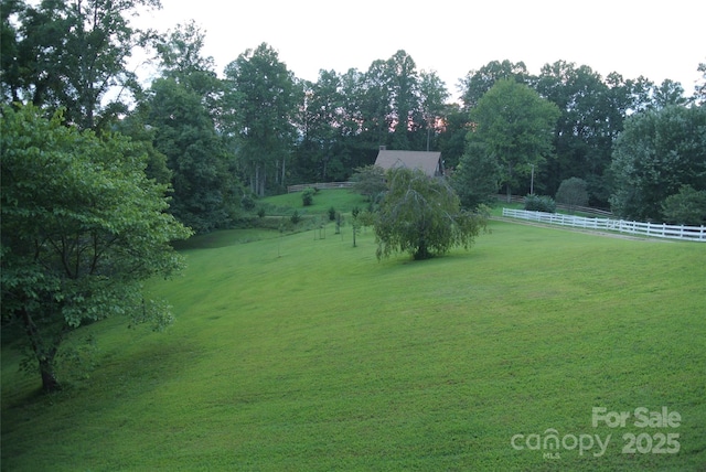 view of yard with a rural view and fence