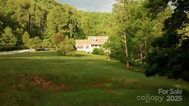 view of yard with a wooded view