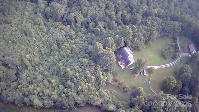 drone / aerial view featuring a forest view