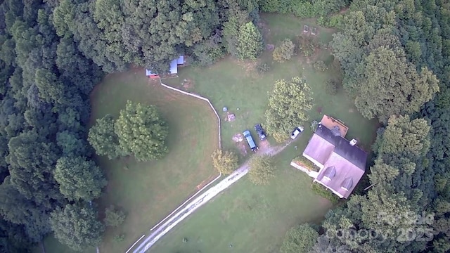 drone / aerial view featuring a view of trees