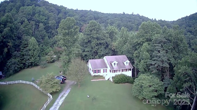 aerial view with a water view and a wooded view