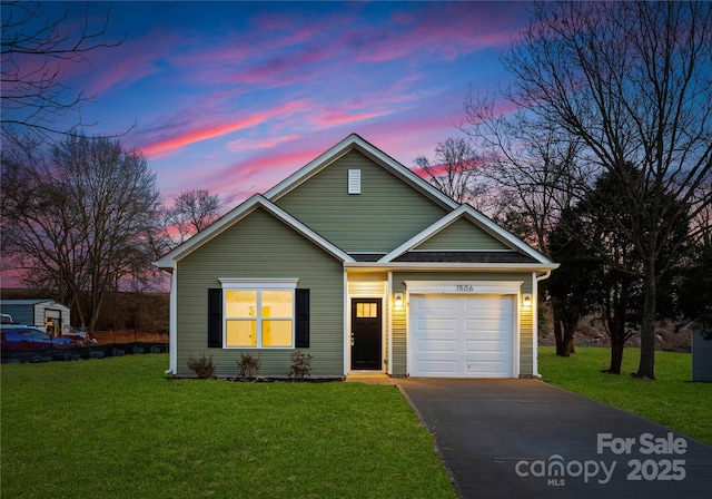 view of front of home featuring a lawn and a garage