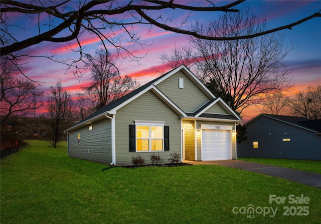 view of front of home featuring a yard and a garage