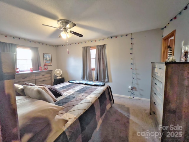 bedroom featuring multiple windows, ceiling fan, and light carpet