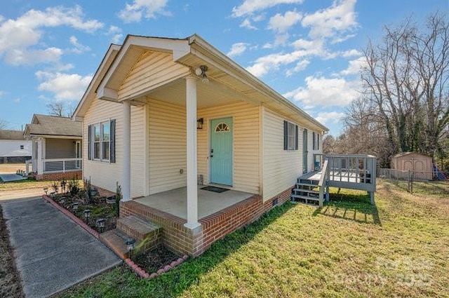 view of front facade with a front yard and a deck