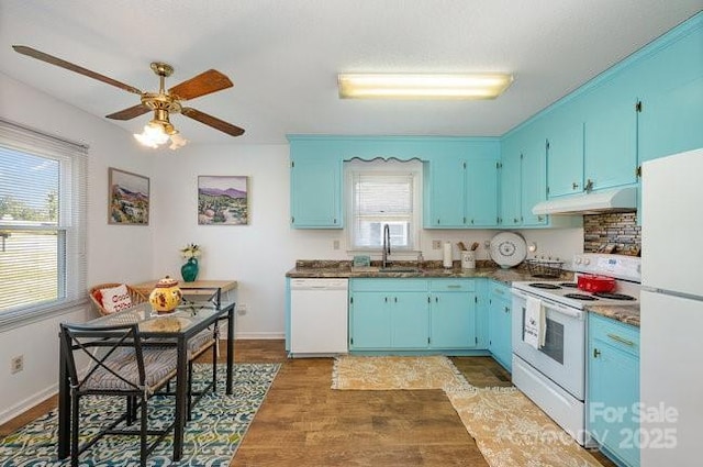 kitchen with blue cabinets, dark hardwood / wood-style flooring, sink, and white appliances