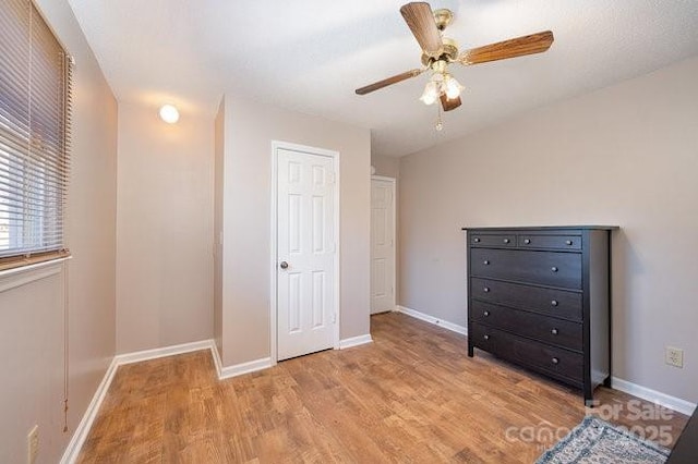 unfurnished bedroom with ceiling fan and light hardwood / wood-style floors