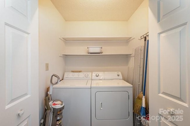 laundry room featuring independent washer and dryer and a textured ceiling