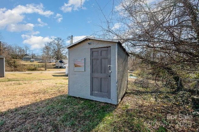 view of outbuilding with a yard