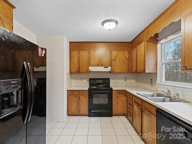 kitchen featuring light tile patterned floors, sink, a textured ceiling, and black appliances