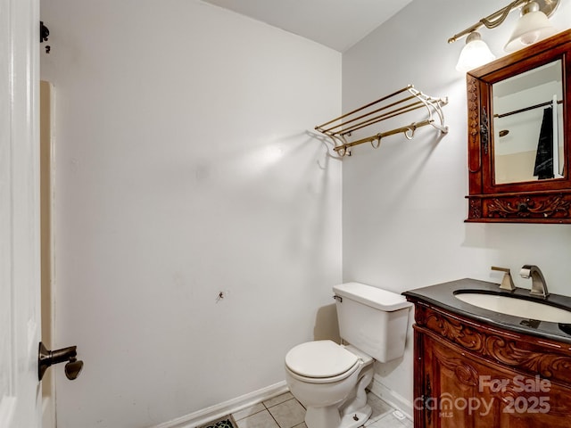 bathroom with vanity, toilet, and tile patterned flooring