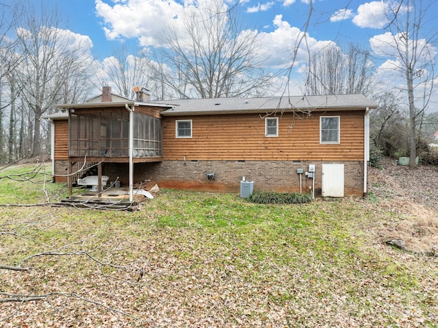 rear view of house featuring a sunroom and central AC