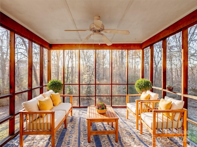 sunroom / solarium featuring ceiling fan