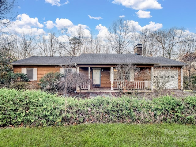 single story home with a chimney, covered porch, and a garage