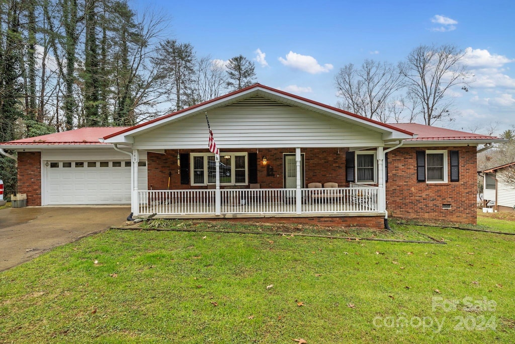 ranch-style home with a porch, a garage, and a front lawn