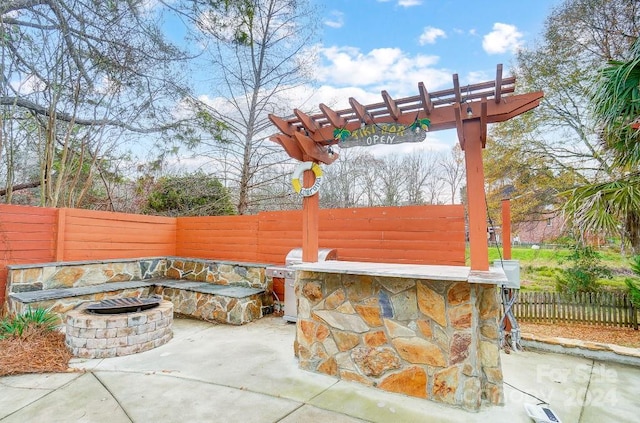 view of patio / terrace with a pergola, grilling area, and an outdoor fire pit