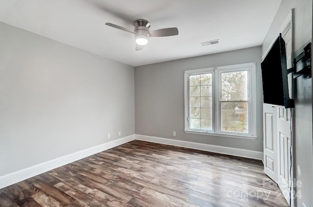 interior space with ceiling fan and dark wood-type flooring